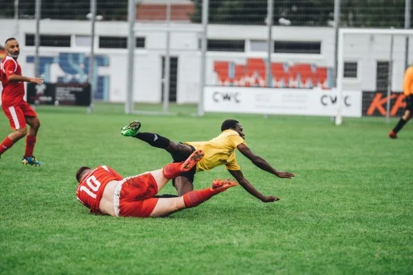 soccer players tackling